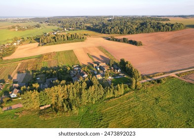 Country houses in countryside, aerial view. Rural landscape. Village wooden house in rural near farm field. Farmhouse in countryside. Suburban house in rural. Roofs of village houses in countryside.  - Powered by Shutterstock