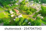 Country houses on large acre land surrounding by lush green trees in suburbs Checotah, small town USA, McIntosh County, Oklahoma, residential neighborhood in agriculture town, aerial view. USA