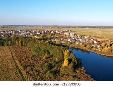 Country houses at river in countryside, aerial view. Building a Home in the Country. Village with wooden house. Suburban house in rural on sunset. Rural building and farmhouse at lake in countryside.  - Shutterstock ID 2125533905