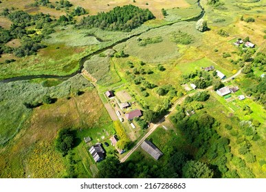 Country Houses At River In Countryside, Aerial View. Building A Home In The Country. Village With Wooden House. Suburban House In Rural On Sunset. Rural Building And Farmhouse At Lake In Countryside. 