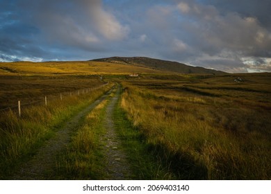 Country Lane Running Up To Irish Cottage In The Irish Hills On Donegal Wild Atlantic Way