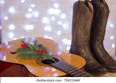 Country Music Christmas With Acoustic Guitar And Cowboy Shoes On Wood