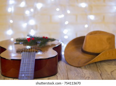 Country Music Christmas With Acoustic Guitar And Cowboy Western Hat On Wood Table