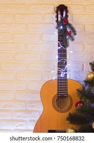 Country Music Christmas Background With Guitar On Brick Wall For Text