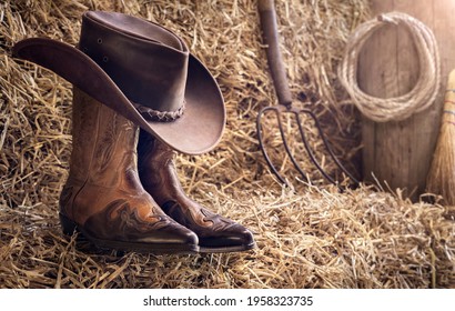Country music festival live concert or rodeo with cowboy hat and boots in barn background