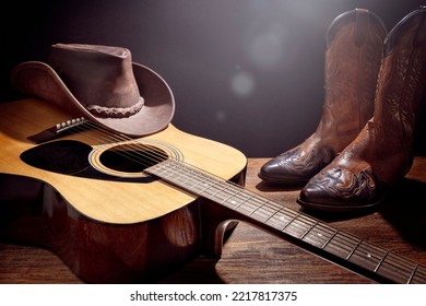 Country music festival live concert with acoustic guitar, cowboy hat and boots background