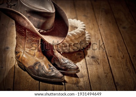 Country music festival live concert or rodeo with cowboy hat and boots background