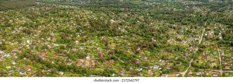 Country residential area with small houses large panoramic aerial view. Rural housing in the woodland from above