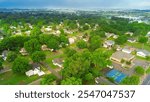 Country residential neighborhood with tennis court near historic downtown Checotah, McIntosh County, Oklahoma and Highway US 69, Midwest small town USA landscape, agriculture town, aerial view. USA