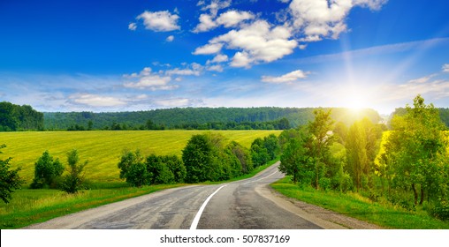 country road and beautiful sunset on sky