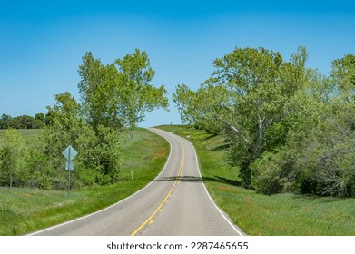 A country road bordered by lush green fields in East Texas in springtime. - Shutterstock ID 2287465655