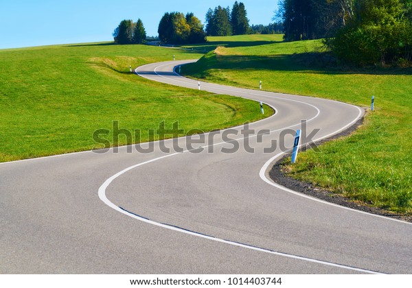 Country road with curve in s form in the Black\
Forest without cars and\
traffic