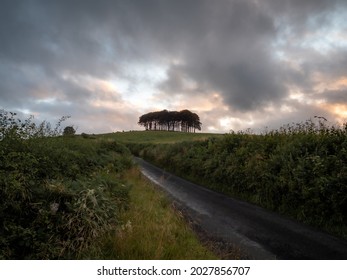 A Country Road In The Foreground Leading Towards The 