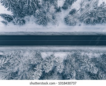 Country Road Going Through The Beautiful Snow Covered Landscapes. Aerial View. Drone Photography