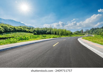 Country road and green forest with mountain natural landscape on a sunny day - Powered by Shutterstock