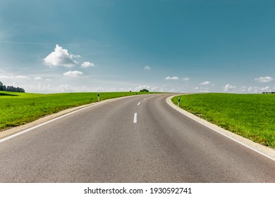 Country Road In Green Landscape To The Horizon