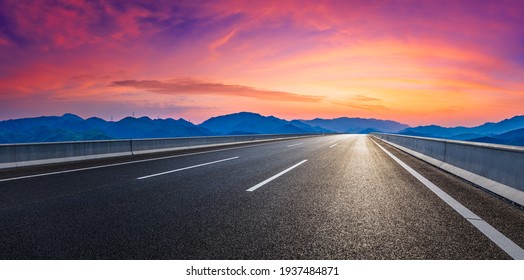 Country road and mountain in summer at sunset.