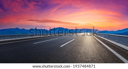 Country road and mountain in summer at sunset.