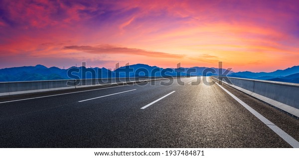 Country road and\
mountain in summer at\
sunset.