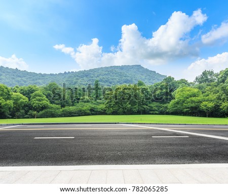 country road and mountains with forest in summer