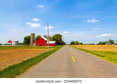Country Road and Red Barn - Shutterstock ID 2254450473