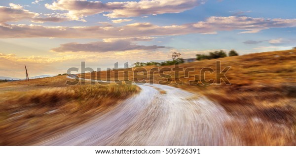 country road at sunset, cloudy backlite shot.\
peferct for car and bike copy\
space