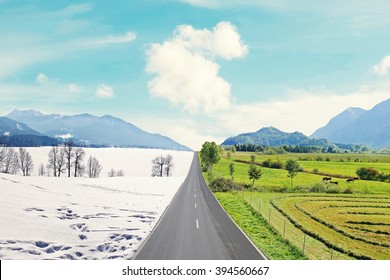 Country Road Through Mountainous Winter And Spring Landscape, Seasons Rotation, Climate Change