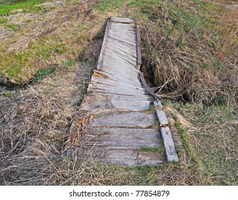 Country Small Broken Foot Bridge Across The Brook