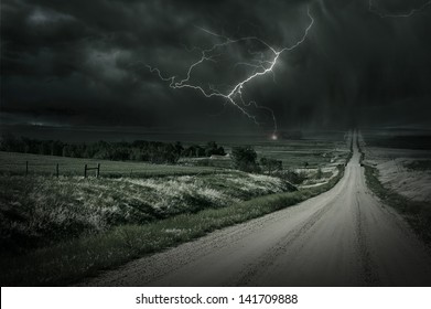 Country Storm. Back Country Gravel Road And Storm Ahead. Lightning Bolt In A Distance. Severe Weather Collection.