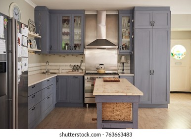 Country Style Kitchen With An Island And Modern Appliances In A Residental Home