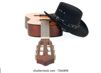 Country & Western guitar and cowboy hat. White background, shallow DOF