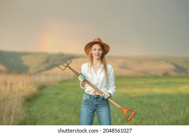 Country Woman In Field With Pitchfork. Harvest Festival