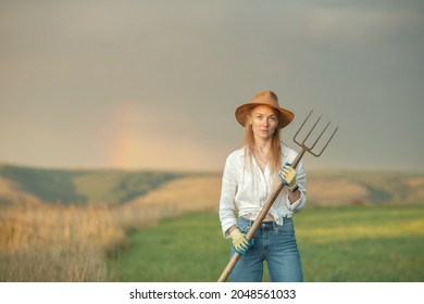 Country Woman In Field With Pitchfork. Harvest Festival