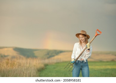 Country Woman In Field With Pitchfork. Harvest Festival