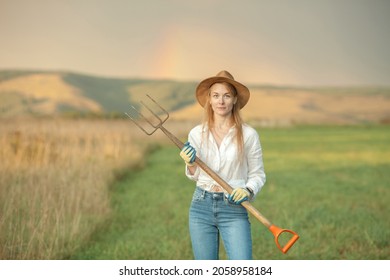 Country Woman In Field With Pitchfork. Harvest Festival