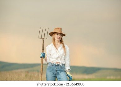 Country Woman In Field With Pitchfork. Harvest Festival