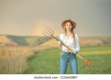 Country Woman In Field With Pitchfork. Harvest Festival