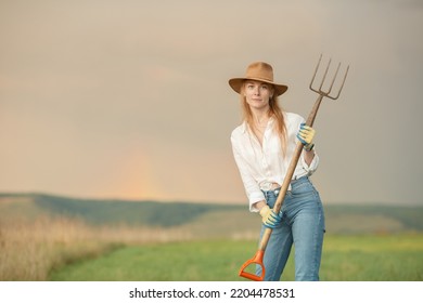 Country Woman In Field With Pitchfork. Harvest Festival