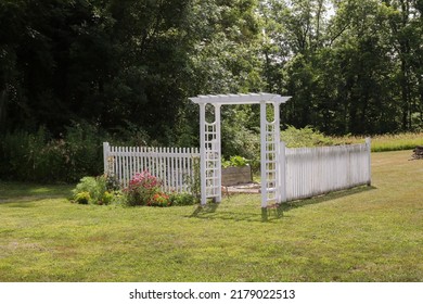 Countryside Flower Garden With White Trellis Arbor And Colorful Blooms