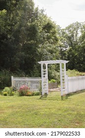 Countryside Flower Garden With White Trellis Arbor And Colorful Blooms