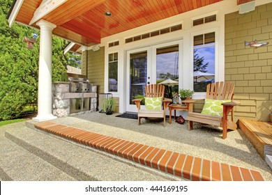 Countryside house exterior. View of column porch with chairs and concrete floor. - Powered by Shutterstock