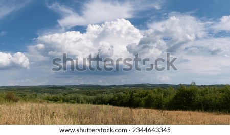 Countryside landscape with cumulonimbus cloud, summer day