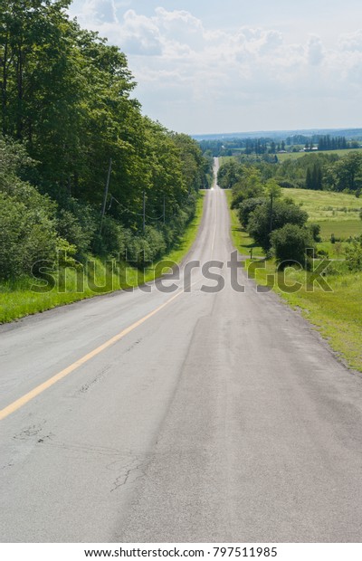 Countryside\
road with hills and downs, Ontario,\
Canada