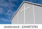 Countryside rural Christian church in Alberta, Canada. White cross on church exterior with beautiful blue sky background. Mennonite Church building architecture