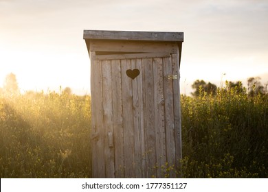 Countryside toilet, wooden shed with heart.