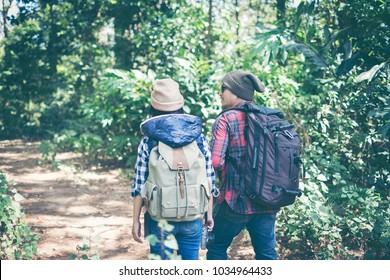 Couple - active hikers hiking enjoying view looking at mountain forest landscape in National Park. Happy multiracial outdoors couple, young Asian woman and man.
 - Powered by Shutterstock