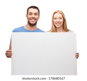 Couple, Advertising And Family Concept - Smiling Couple Holding White Blank Board