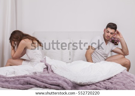couple after quarrel in bed woman crying man tries to calm the situation