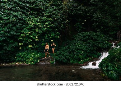 Couple Among The Greenery. A Couple In Love In The Tropics. The Couple Is Traveling In Asia. Beautiful Couple Traveling On The Island Of Bali. Man And Woman On The Background Of Nature. Copy Space