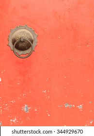 Couple Of Antique Brass Ring Pull Handles On Red Door